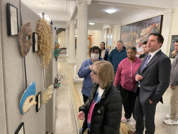 Adults admire artwork exhibit