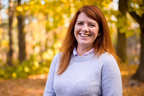 Woman who is a member of Advocates peer specialist team smiling outdoors.